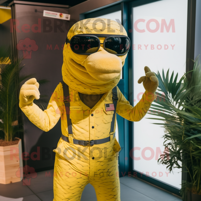 Yellow Anaconda mascot costume character dressed with a Dungarees and Sunglasses Yellow Anaconda mascot costume character dressed with a Dungarees and Sunglasses