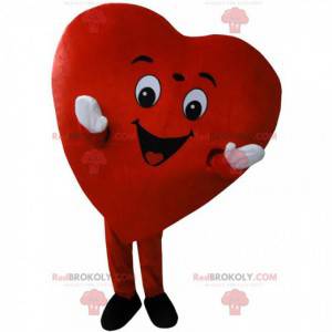 Mascota de corazón rojo gigante, traje romántico y sonriente -