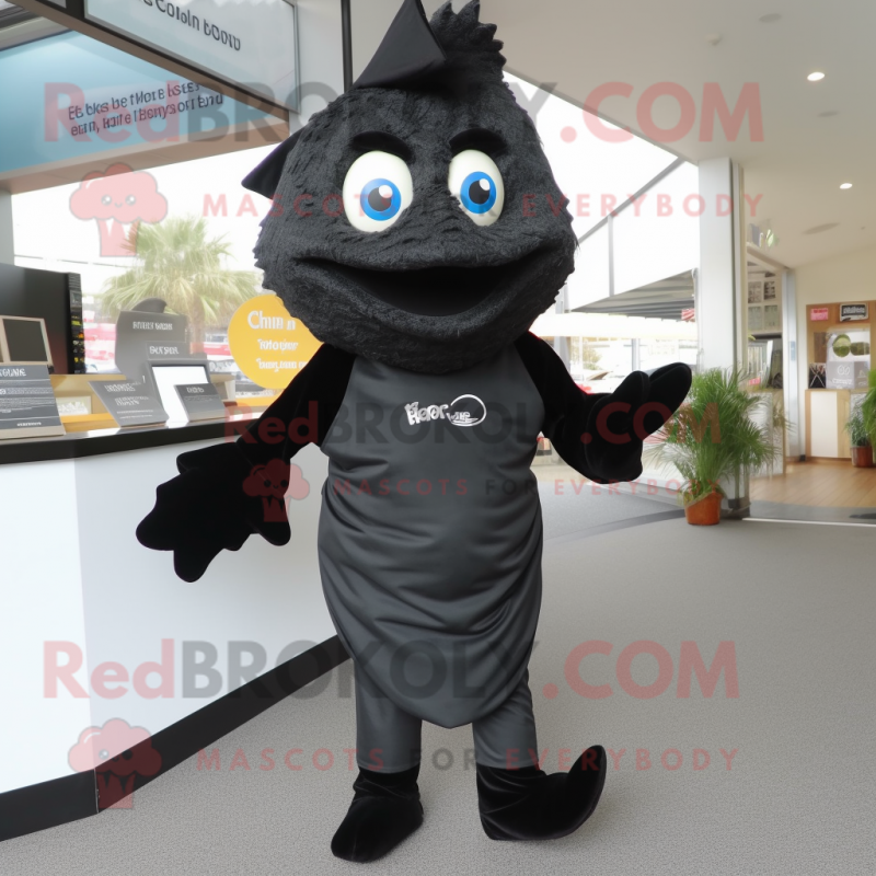 Black Fish And Chips mascot costume character dressed with a Jeggings and Brooches