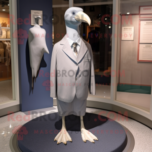 Silver Albatross mascot costume character dressed with a Sheath Dress and Ties