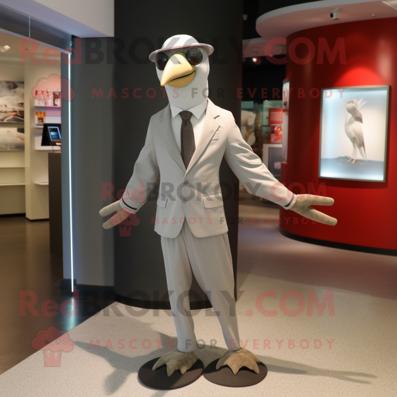 Silver Albatross mascot costume character dressed with a Sheath Dress and Ties Silver Albatross mascot costume character dressed with a Sheath Dress and Ties