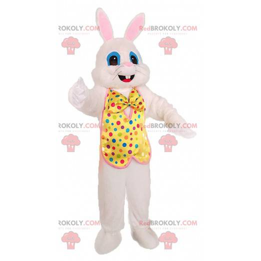 White rabbit mascot with a yellow vest with colored dots -