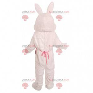 White rabbit mascot with a yellow vest with colored dots -