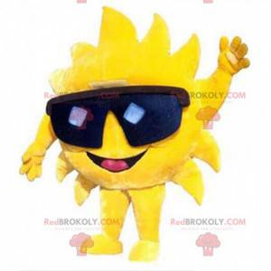 Gigantyczna żółta maskotka słońce w czarnych okularach -
