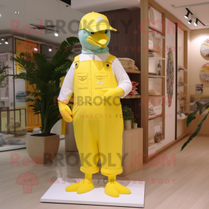 Lemon Yellow Dove mascot costume character dressed with a Dungarees and Hat pins