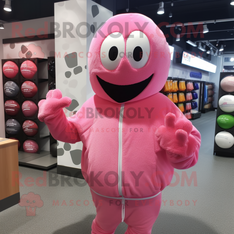 Pink Golf Ball mascot costume character dressed with a Hoodie and Headbands Pink Golf Ball mascot costume character dressed with a Hoodie and Headbands