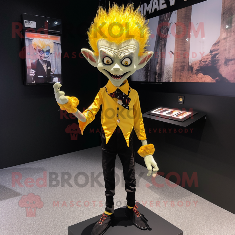 Yellow Vampire mascot costume character dressed with a Oxford Shirt and Hair clips Yellow Vampire mascot costume character dressed with a Oxford Shirt and Hair clips
