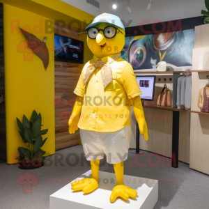 Lemon Yellow Pigeon mascot costume character dressed with a Shorts and Eyeglasses