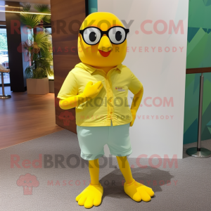 Lemon Yellow Pigeon mascot costume character dressed with a Shorts and Eyeglasses