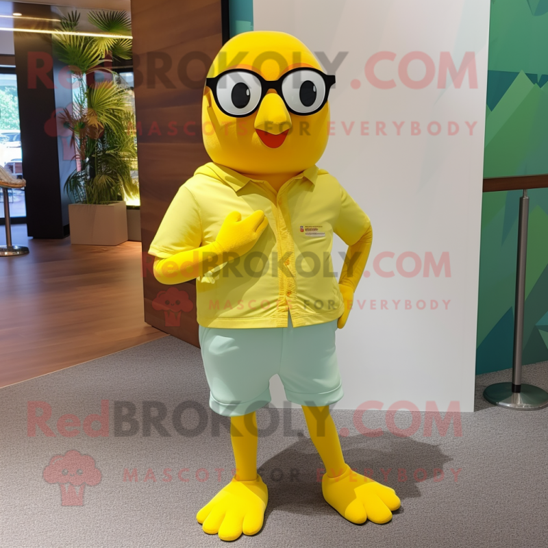 Lemon Yellow Pigeon mascot costume character dressed with a Shorts and Eyeglasses Lemon Yellow Pigeon mascot costume character dressed with a Shorts and Eyeglasses
