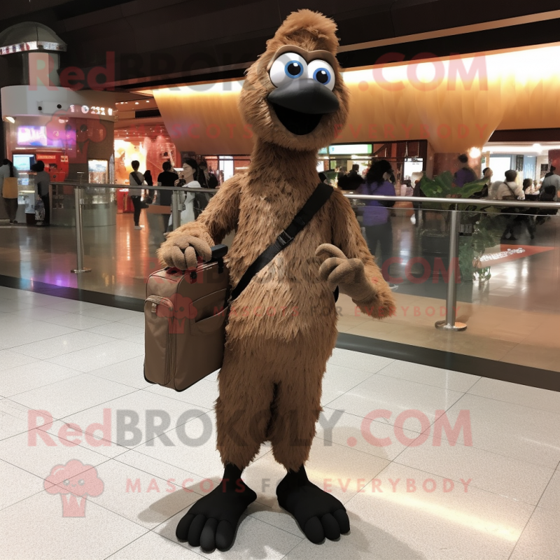 Brown Ostrich mascot costume character dressed with a Jumpsuit and Messenger bags Brown Ostrich mascot costume character dressed with a Jumpsuit and Messenger bags