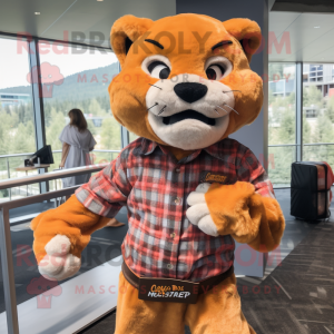 Orange Mountain Lion mascot costume character dressed with a Flannel Shirt and Pocket squares