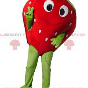 Strawberry maskot flirtig med ett vackert leende -