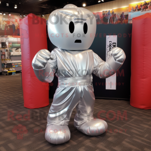 Silver Boxing Glove mascot costume character dressed with a Wrap Skirt and Backpacks