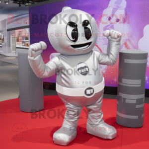 Silver Boxing Glove mascot costume character dressed with a Wrap Skirt and Backpacks