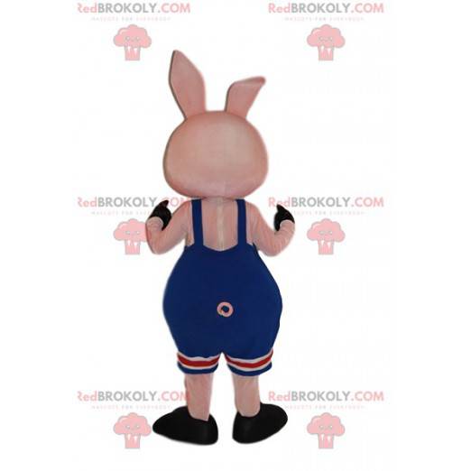 Kleine roze varken mascotte met zijn blauwe overall -