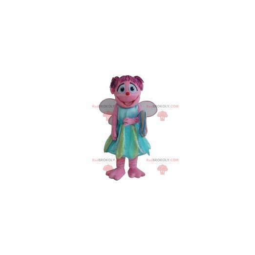 Mascota de hadas rosa con su bonito vestido azul y verde -