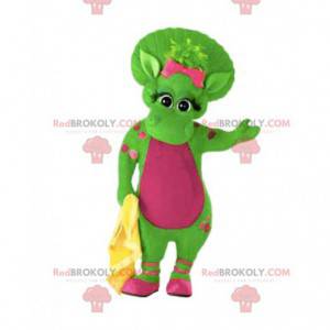 Mascote de dinossauro fêmea verde com bolinhas rosa e seu