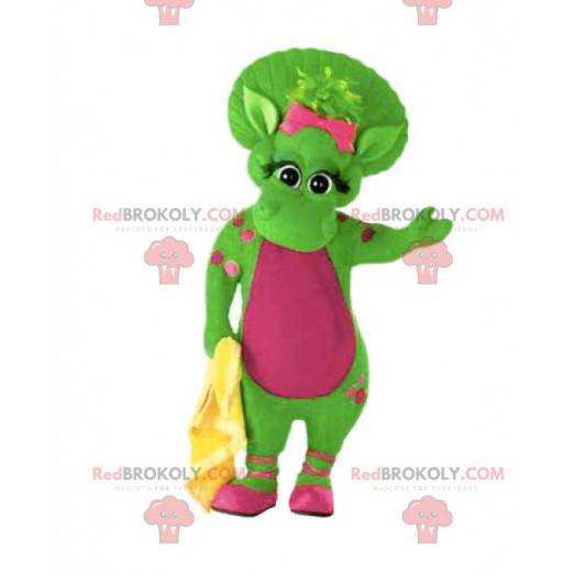 Groene vrouwelijke dinosaurusmascotte met roze stippen en haar