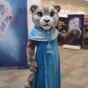 Blue Mountain Lion mascot costume character dressed with a Empire Waist Dress and Wraps