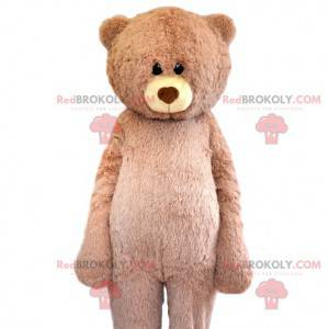 Mascote urso bege muito fofo com seu olhar terno -