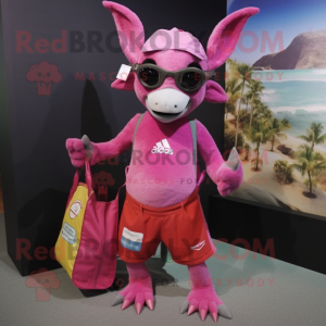 Pink Chupacabra mascot costume character dressed with a Board Shorts and Tote bags