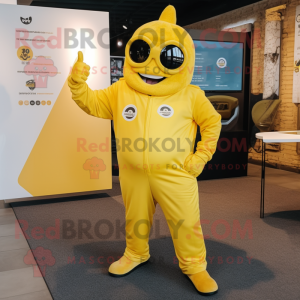 Yellow Momentum mascot costume character dressed with a Jumpsuit and Foot pads