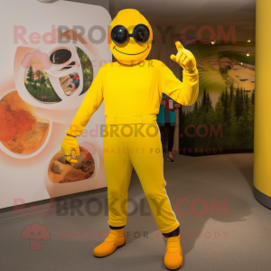 Yellow Momentum mascot costume character dressed with a Jumpsuit and Foot pads