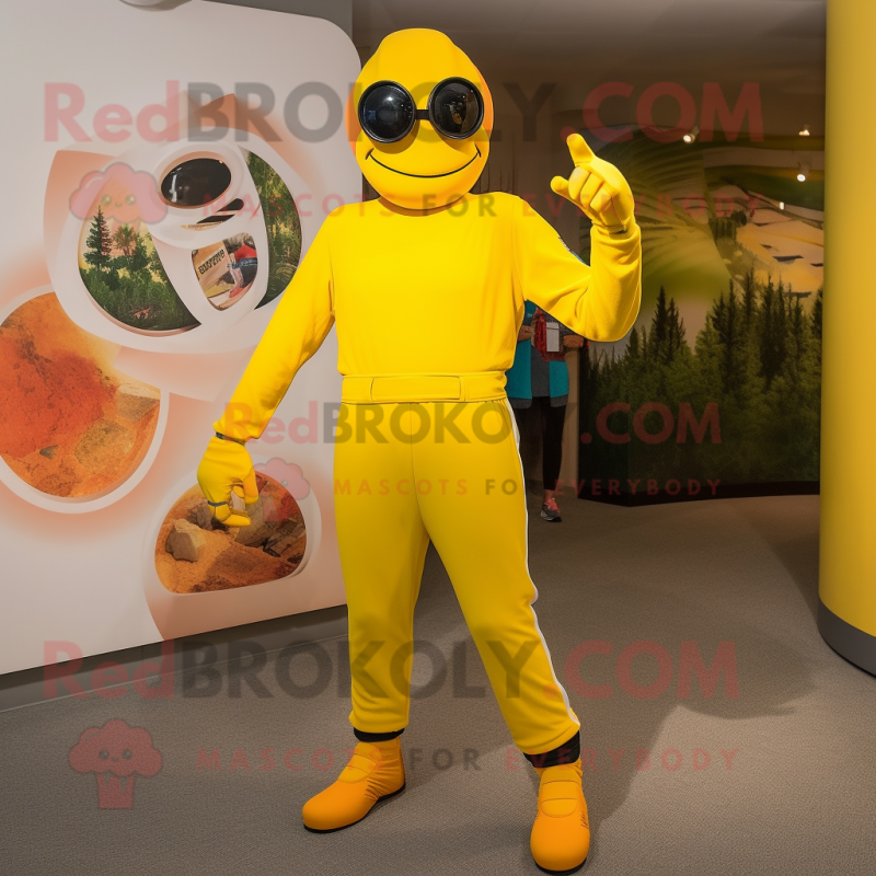 Yellow Momentum mascot costume character dressed with a Jumpsuit and Foot pads Yellow Momentum mascot costume character dressed with a Jumpsuit and Foot pads