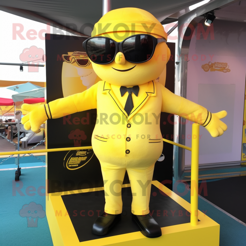 Lemon Yellow Trapeze Artist mascot costume character dressed with a Waistcoat and Sunglasses