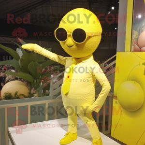 Lemon Yellow Trapeze Artist mascot costume character dressed with a Waistcoat and Sunglasses