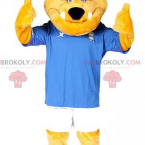 Mascotte del cane giallo con il suo vestito da calcio blu e