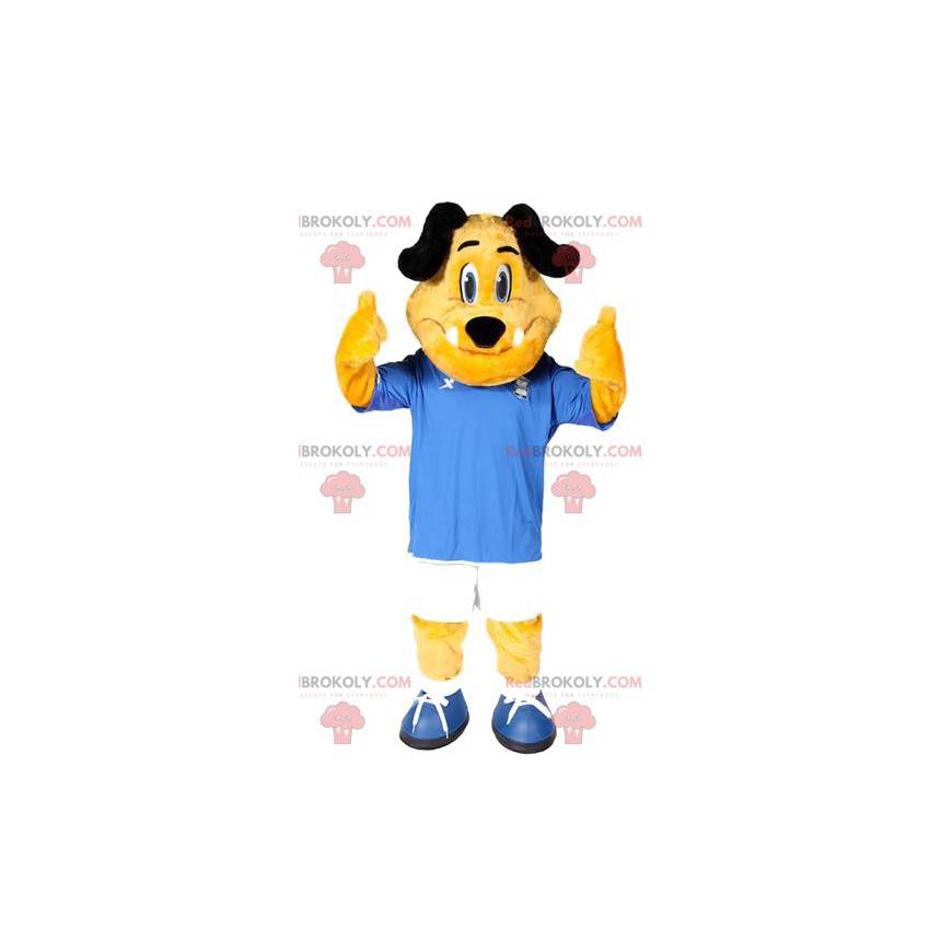 Mascotte de chien jaune avec sa tenue de foot bleue et blanche Mascotte de chien jaune avec sa tenue de foot bleue et blanche