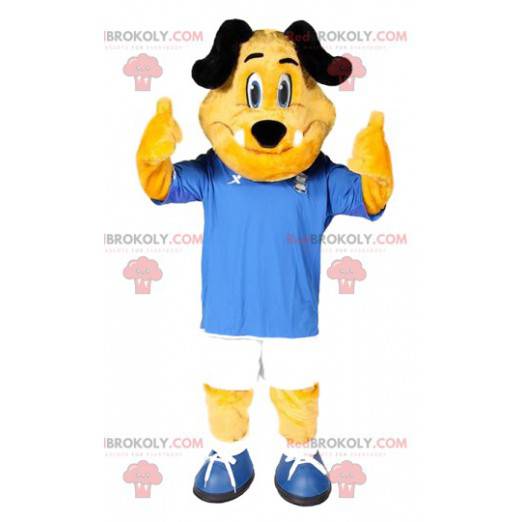 Żółty pies maskotka z jego niebiesko-białym strojem piłkarskim