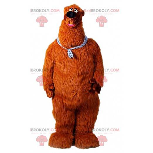 Giant brown bear mascot with a bandana around his neck -