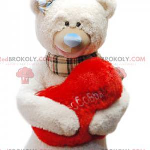 Mascotte orso beige coccolone con il suo cuscino rosso "Cuore"