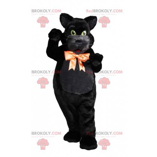 Black cat macsotte with green eyes with its orange bow -