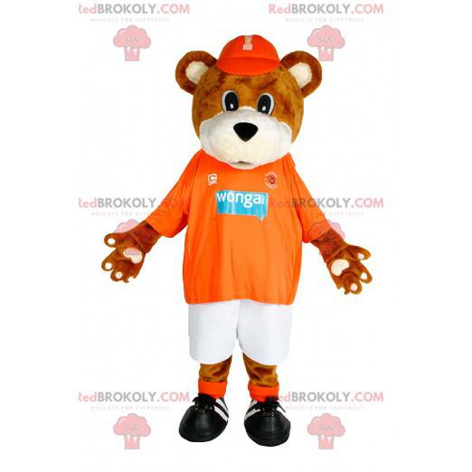 Brun bjørnemaskot med sin orange trøje til støtte -