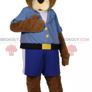 Mascota del oso pardo en pantalones cortos azules y camisa -