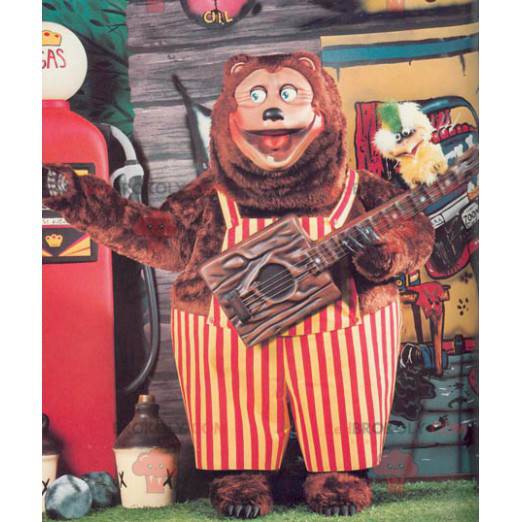 Big brown bear mascot with red and yellow overalls -