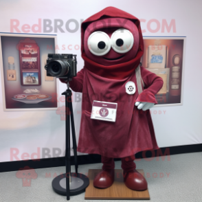 Maroon Camera mascot costume character dressed with a Oxford Shirt and Shawl pins