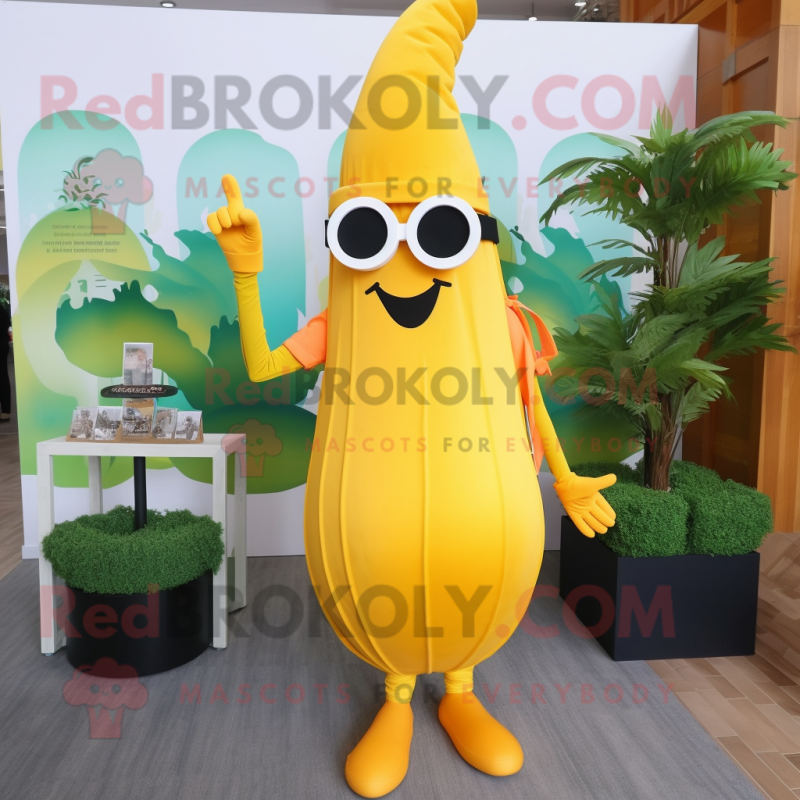 Yellow Carrot mascot costume character dressed with a Maxi Dress and Sunglasses Yellow Carrot mascot costume character dressed with a Maxi Dress and Sunglasses