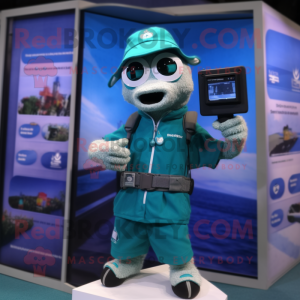 Teal Camera mascot costume character dressed with a Board Shorts and Digital watches