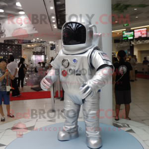 Silver Astronaut mascot costume character dressed with a Cover-up and Keychains