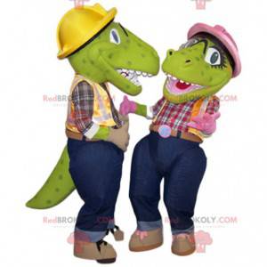 Twee groene dinosaurusmascottes in klusjesmanoutfit -