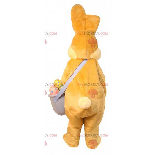 Easter bunny mascot with a basket of chocolate eggs -