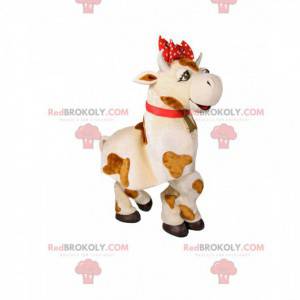 Mascotte mucca bianca e marrone con un fiocco rosso -