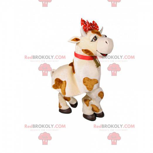Mascotte de vache blanche et marron avec un nœud rouge -