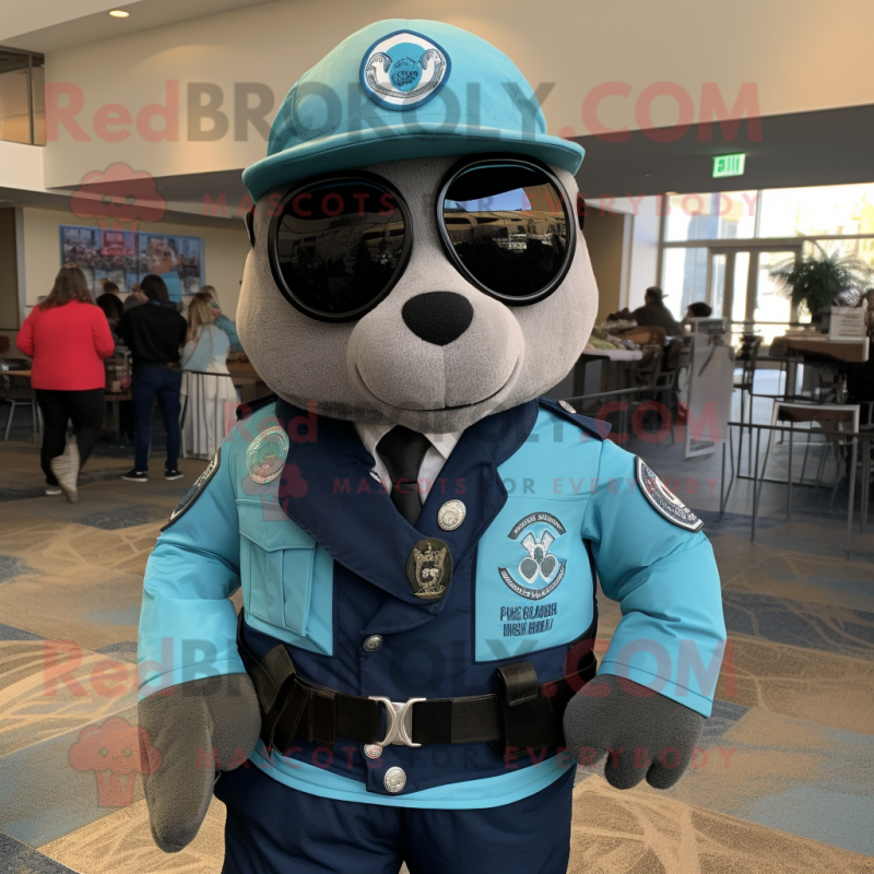 Teal Navy Seal mascot costume character dressed with a Moto Jacket and Tie pins Teal Navy Seal mascot costume character dressed with a Moto Jacket and Tie pins