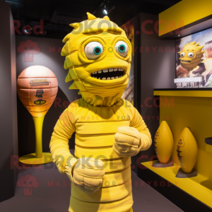 Yellow Mummy mascot costume character dressed with a Rugby Shirt and Earrings